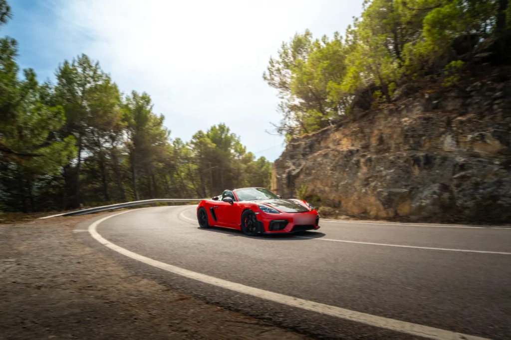 Porsche 718 rojo en curva en la ruta RX04 Villahermosa de Road Experience, ruta en coche deportivo por Castellón